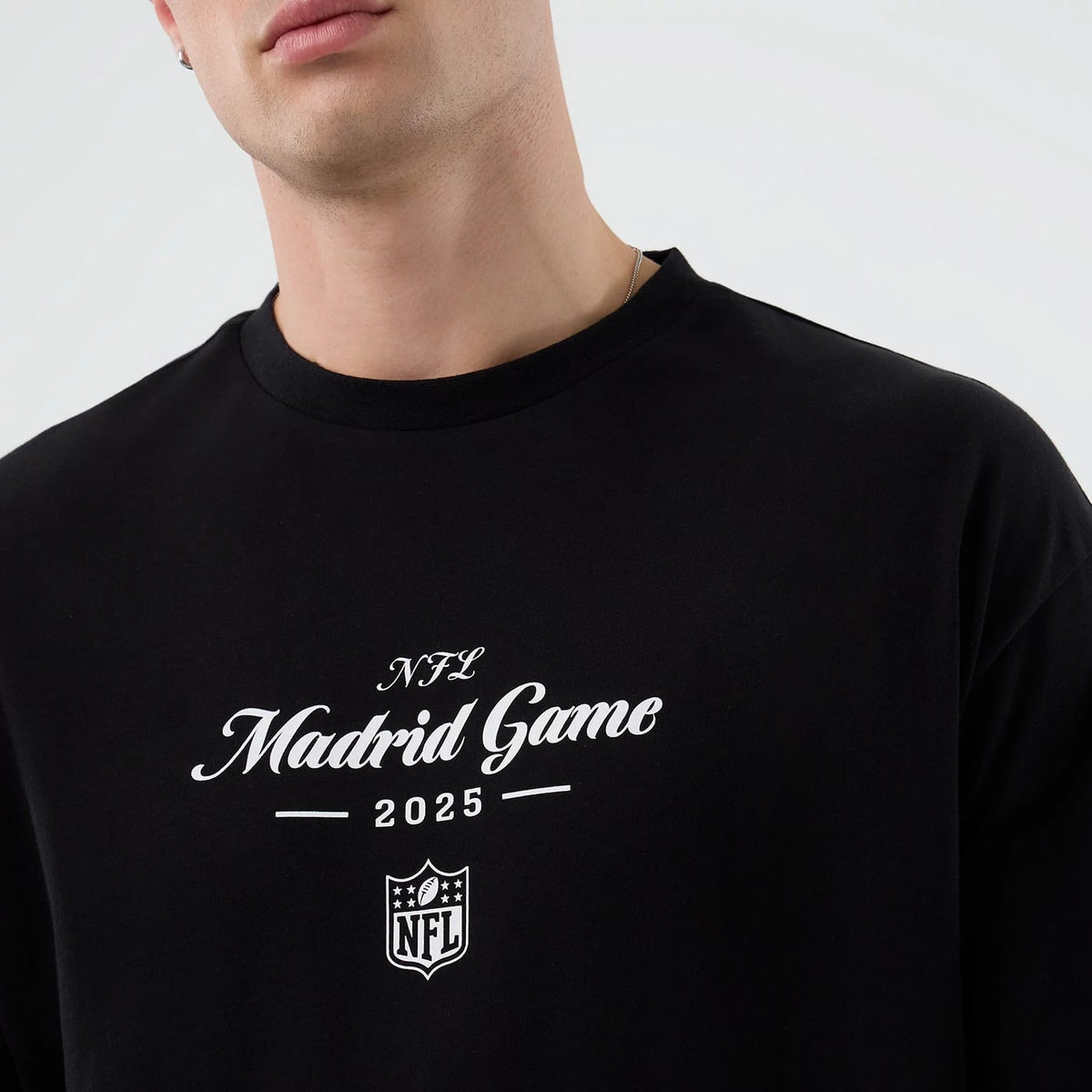 The Male model is wearing Madrid Game NFL International Series Games Black Oversized T-Shirt 3