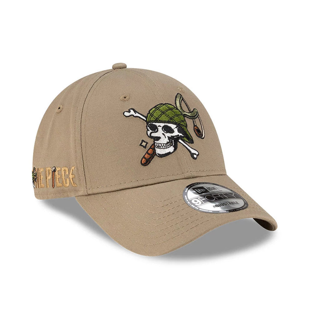 One Piece Usopp Beige New Era 9FORTY Adjustable Cap, three-quarter view showing a colourful embroidered skull and crossbones on the front panel, a curved visor with a 9FORTY size sticker, and the One Piece logo on the side in gold.