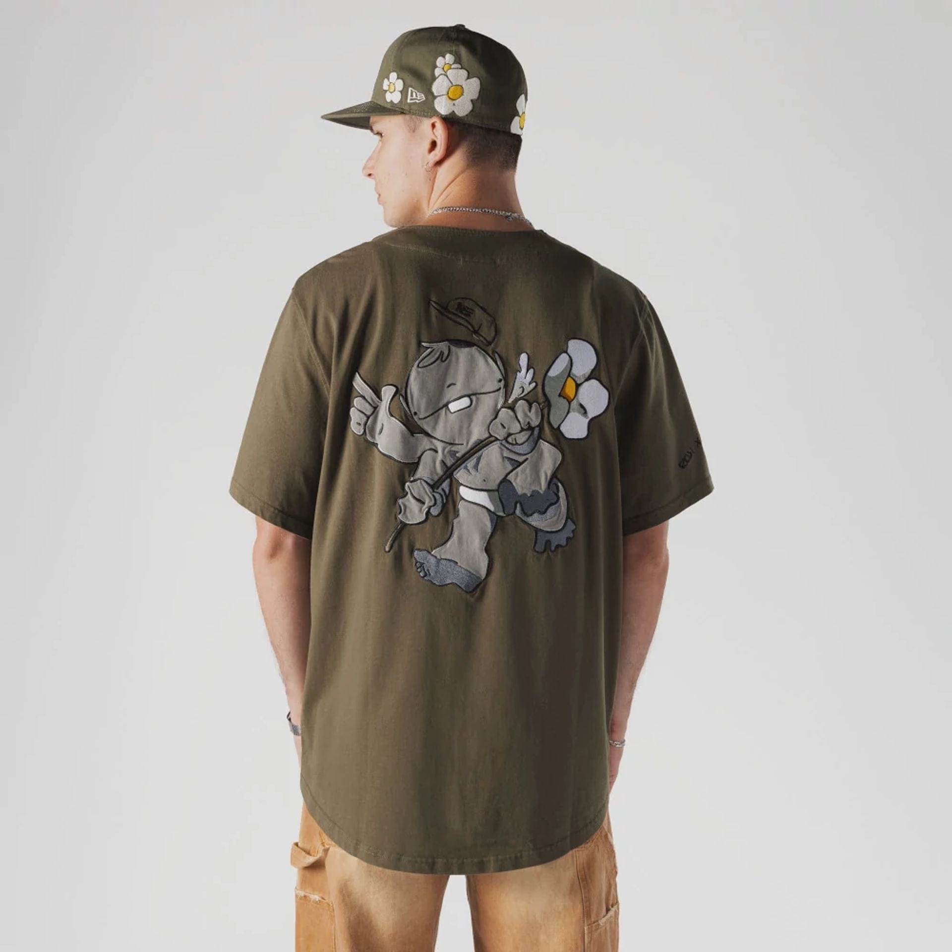 The Male model is wearing New Era x Rodrigo Roji Flower Green Jersey 2