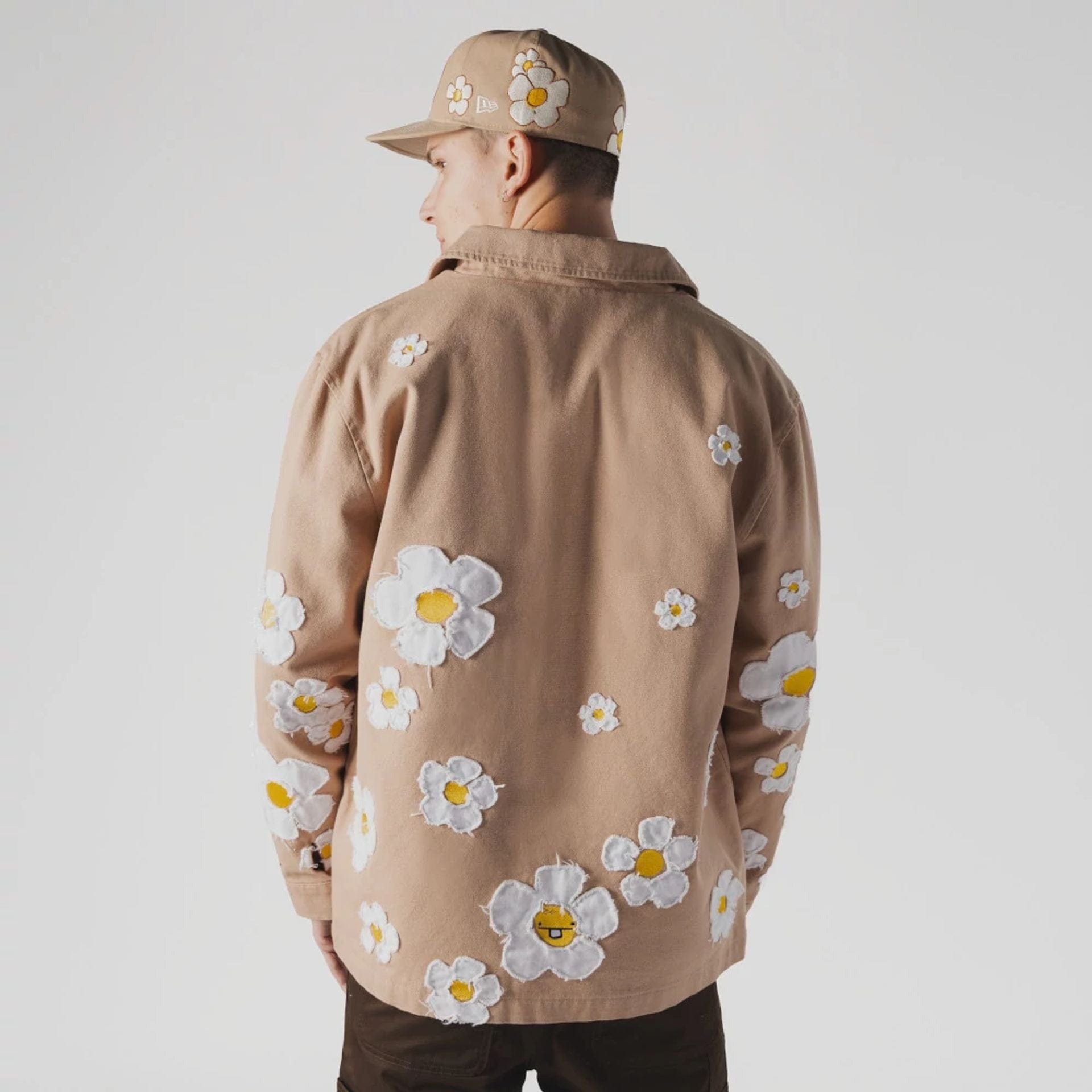 The Male model is wearing New Era x Rodrigo Roji Flower Light Beige Jacket 2