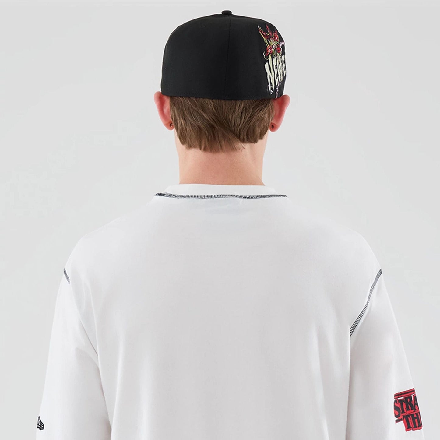 The Male model is wearing Stranger Things White Oversized T-Shirt 7