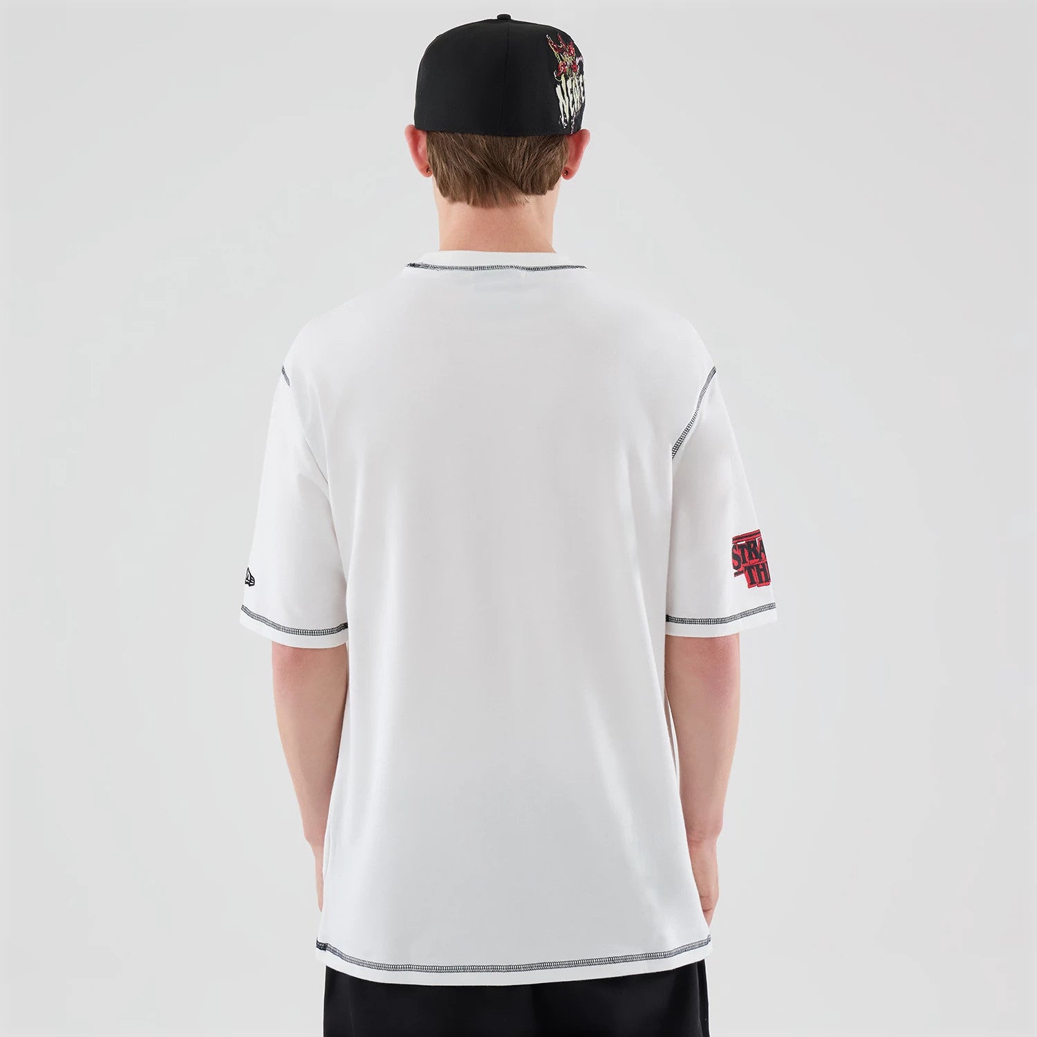 The Male model is wearing Stranger Things White Oversized T-Shirt 2
