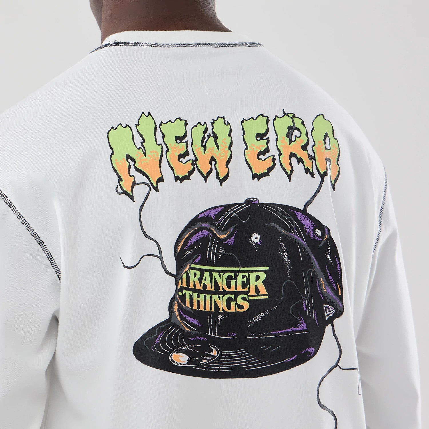 The Male model is wearing Stranger Things White Oversized Long Sleeve T-Shirt 4