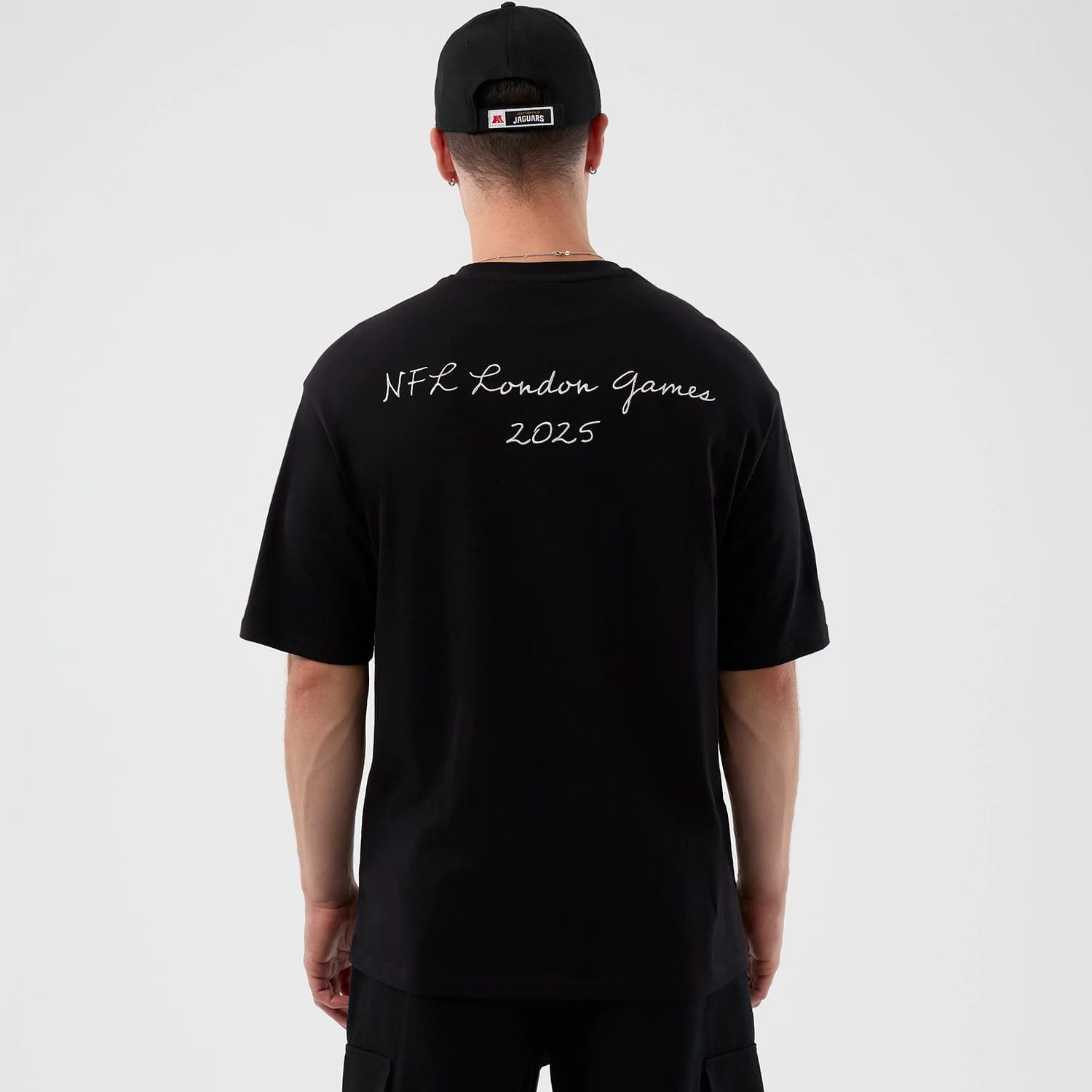 The Male model is wearing Jacksonville Jaguars NFL International Series Games Script Black Oversized T-Shirt 2