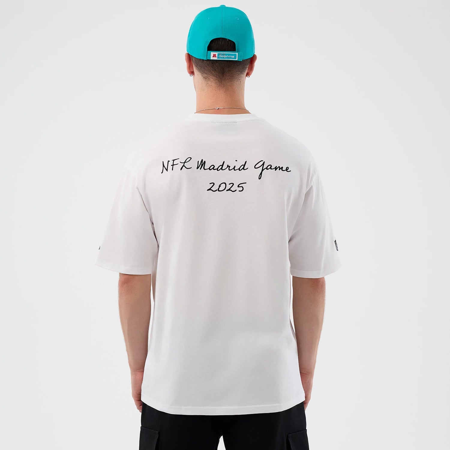 The Male model is wearing Miami Dolphins NFL International Series Games Script White Oversized T-Shirt 2