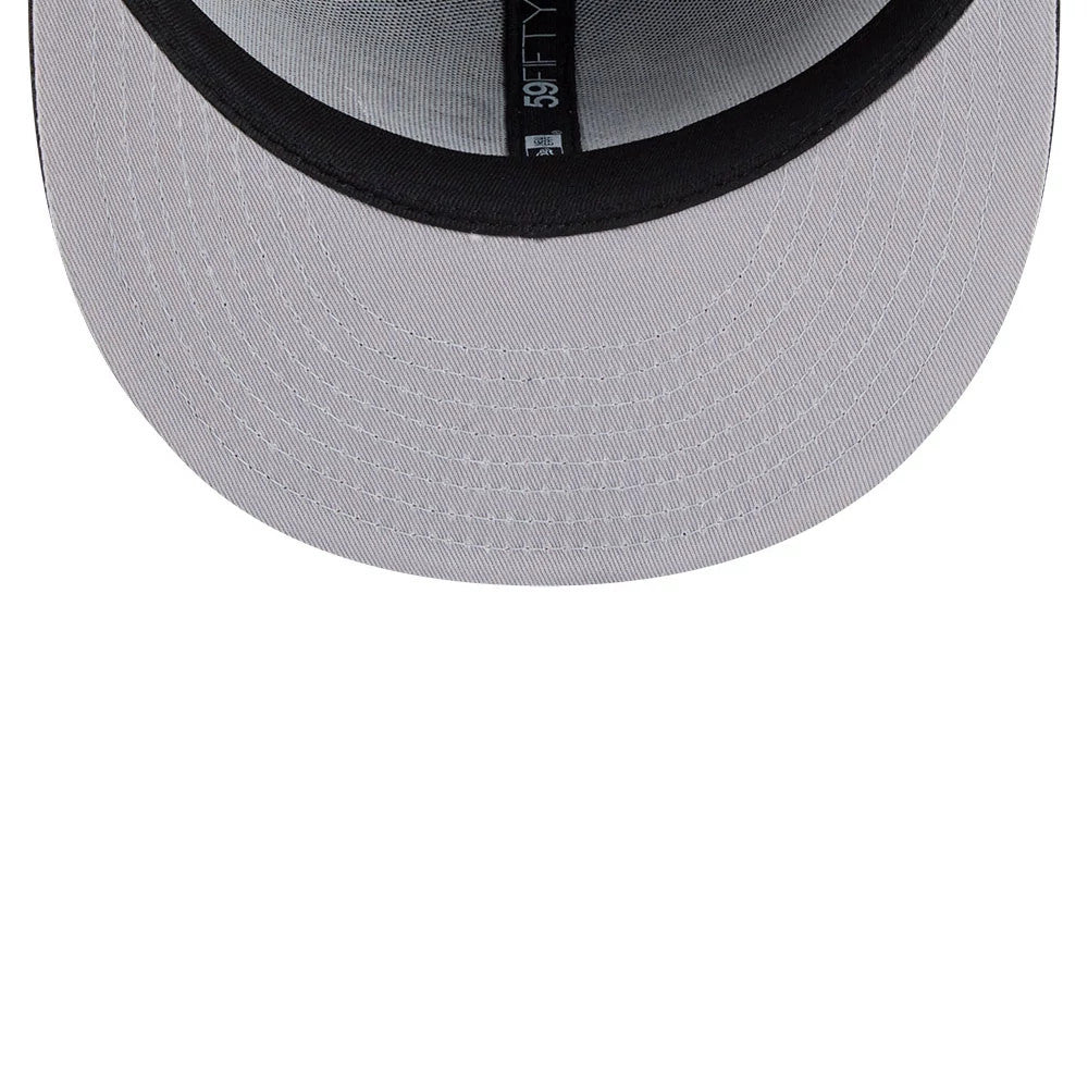 LA Kings NHL Evergreen Black New Era 59FIFTY Fitted Cap, inside view showing the grey undervisor, black sweatband, and black-on-white 59FIFTY taping across the interior crown, with a partially size tag.