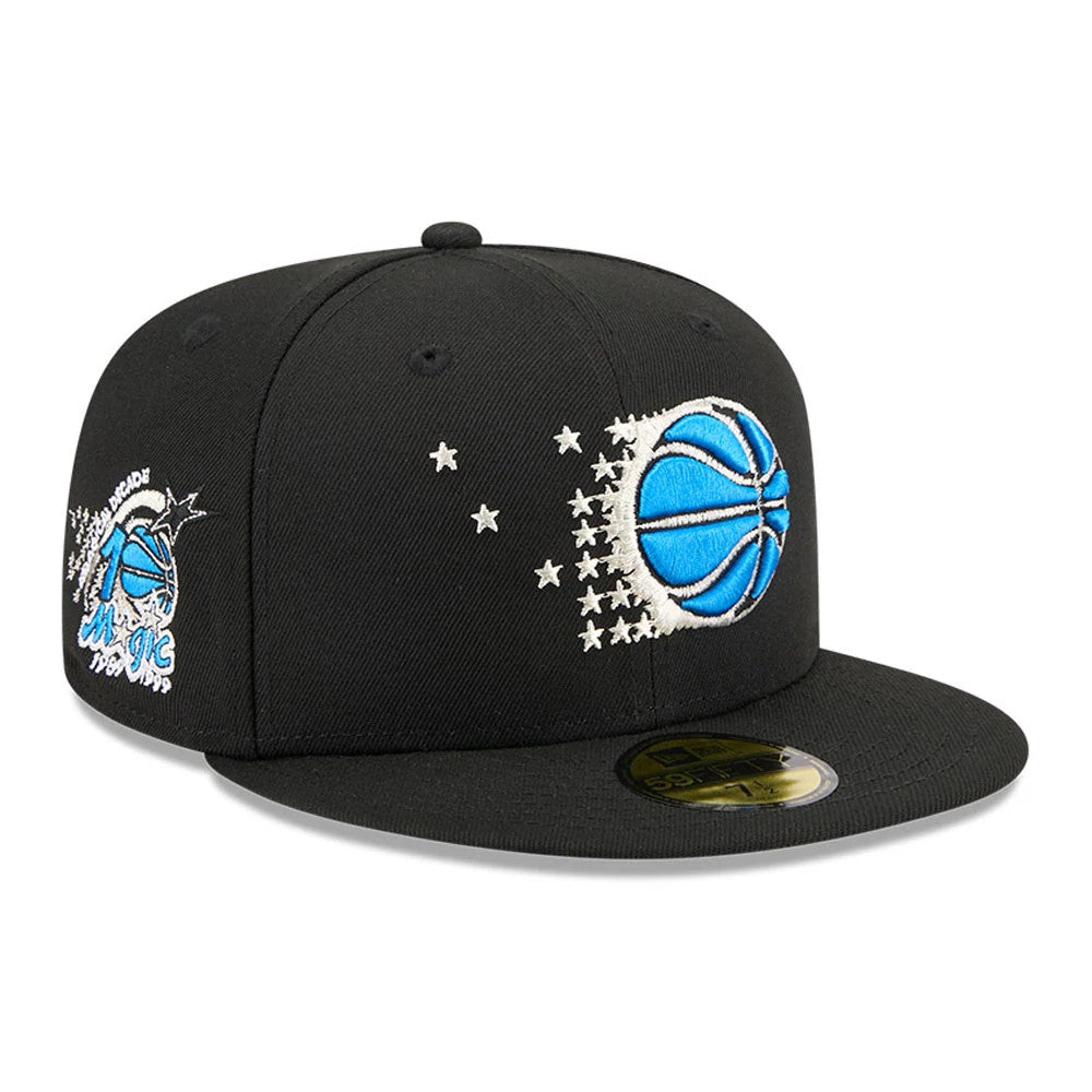 Orlando Magic NBA Hardwood Classic Black New Era 59FIFTY Fitted Cap, three-quarter view showing a large blue and white embroidered basketball logo with stars shooting across the front panels, and a gold 59FIFTY size sticker on the flat black visor.