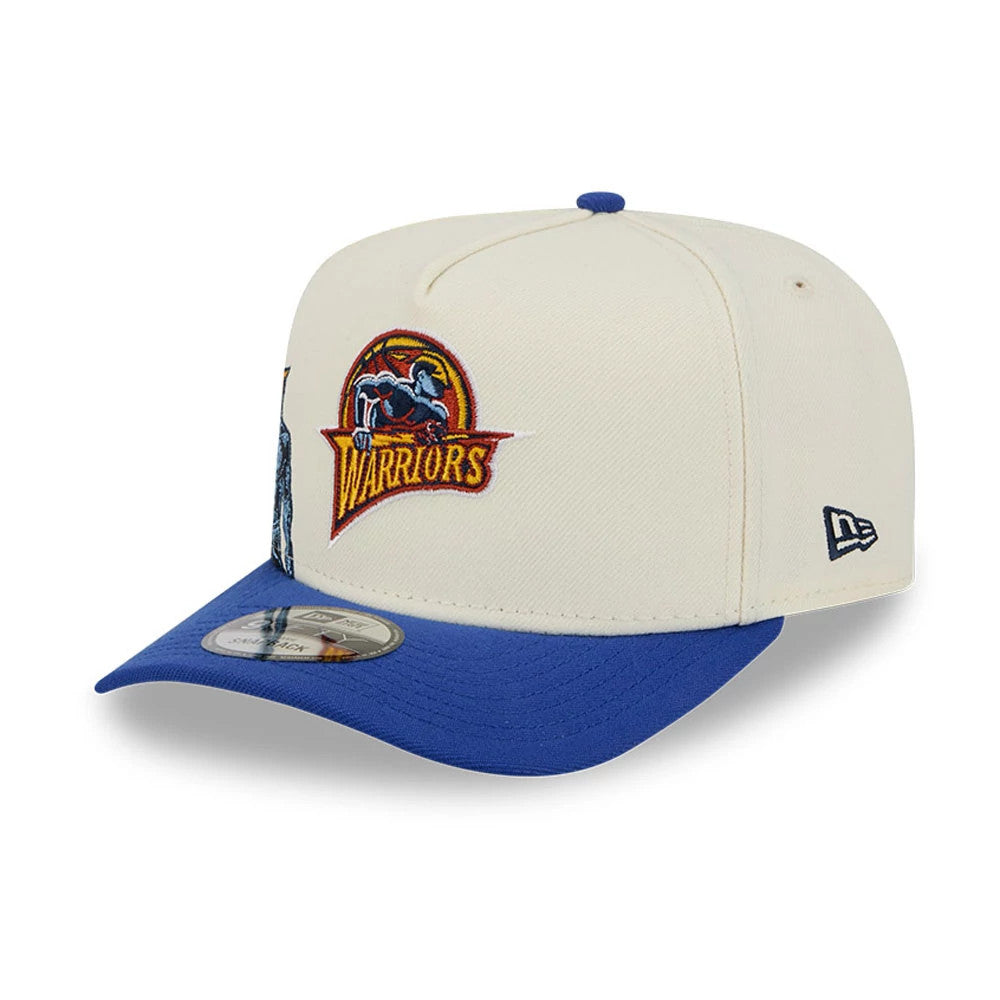 Golden State Warriors NBA Blue New Era 9FIFTY A-Frame Snapback Adjustable Cap, three-quarter view with a raised retro Warriors logo on the front panel, blue flat visor with a 9FIFTY size sticker, and New Era flag logo on the left side.