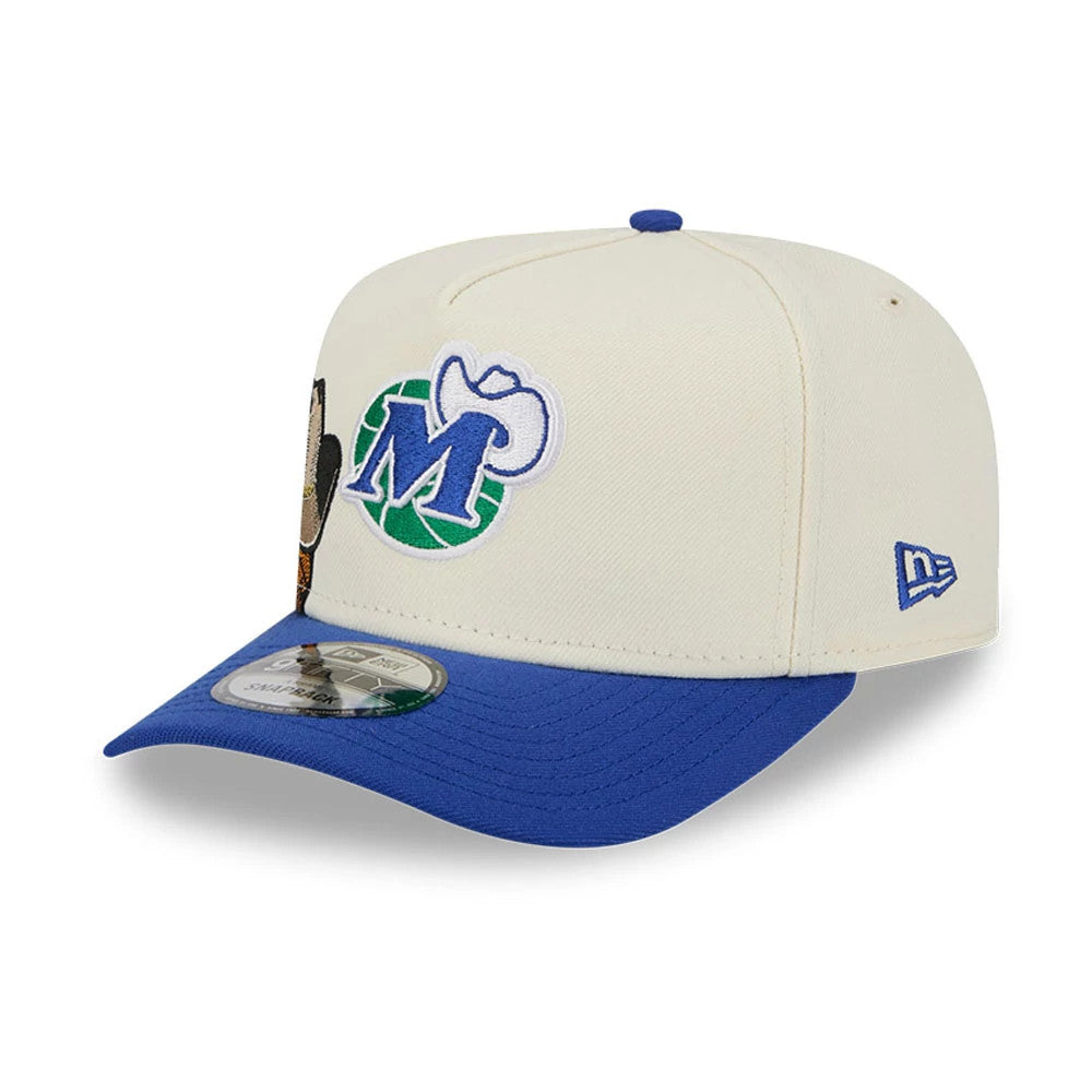 Dallas Mavericks NBA Blue New Era 9FIFTY A-Frame Snapback Adjustable Cap, three-quarter view showing the embroidered Mavericks logo on the front panel, contrasted with a blue curved visor and a 9FIFTY size sticker.