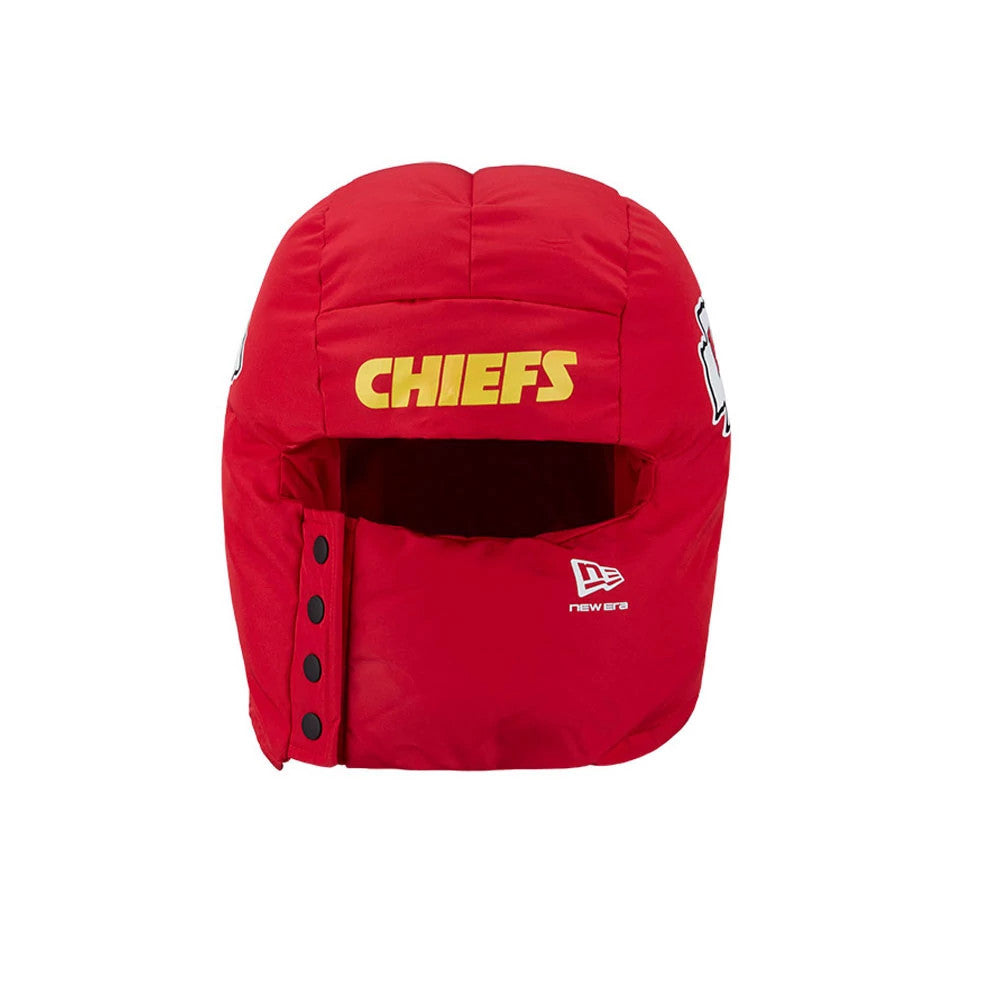 New Era Kansas City Chiefs NFL Puffer Helmet Red Trapper Hat, front view showing the yellow CHIEFS lettering embroidered on the crown, New Era flag logo on the left side, and black snap closures on the right flap.