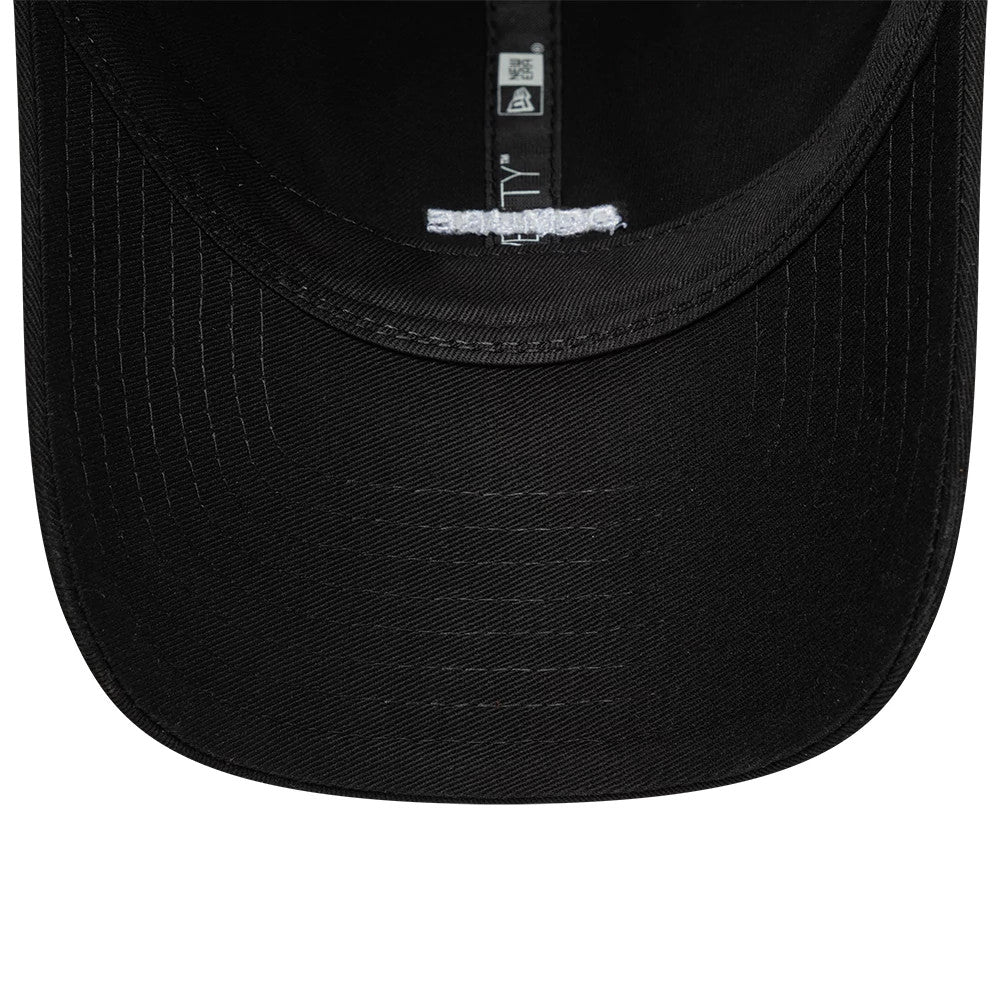 New Era Slogan Demure Black 9TWENTY Adjustable Cap, inside view showing black undervisor and interior taping with the white New Era logo, highlighting the adjustable strap and black sweatband.