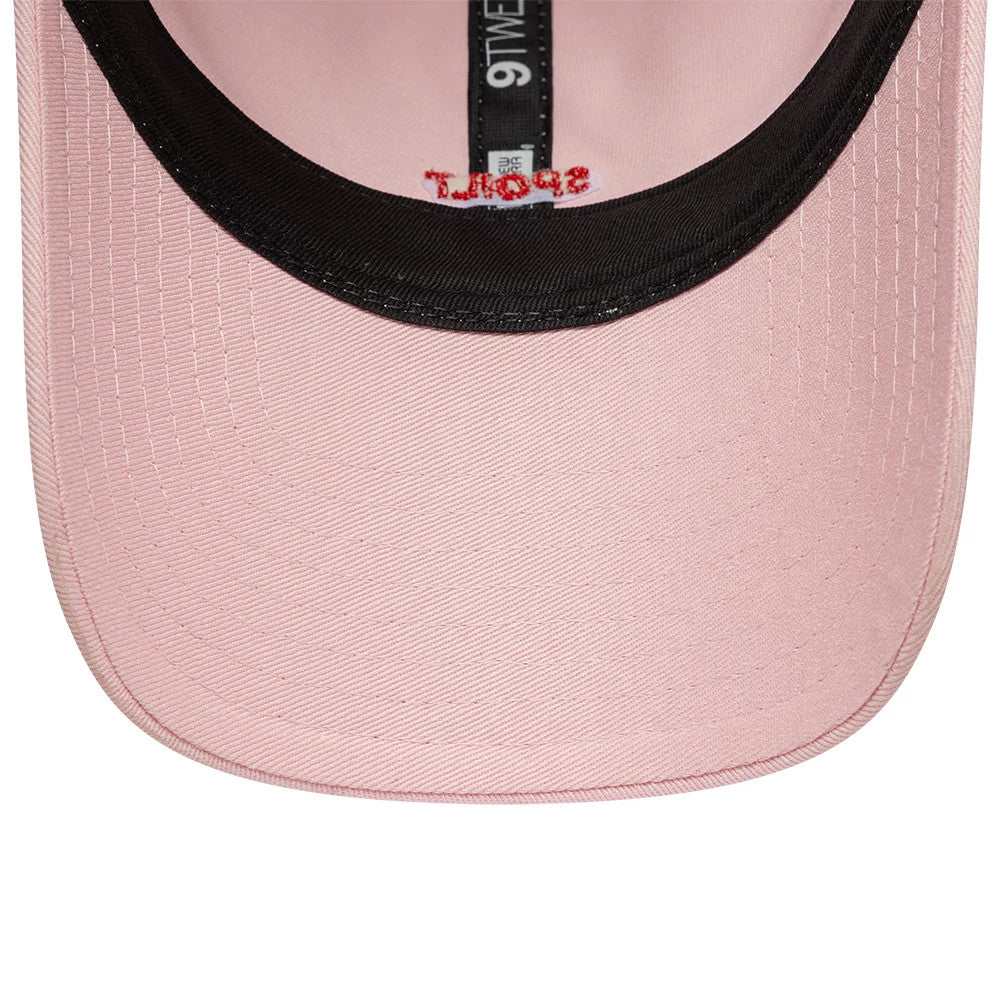 New Era Slogan Spoilt Pastel Pink 9TWENTY Adjustable Cap, inside view showing the black sweatband with embroidered red Through text, light pink undervisor and taping with the white 9TWENTY label.