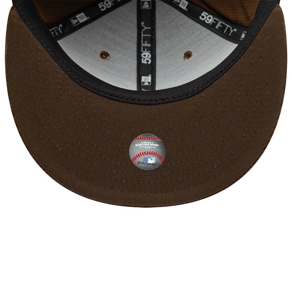 Atlanta Braves MLB Cord Dark Brown New Era 59FIFTY Fitted Cap, inside view showing black taping with 59FIFTY branding, grey sweatband, a Major League Baseball sticker on the brown undervisor, and brown interior eyelets.