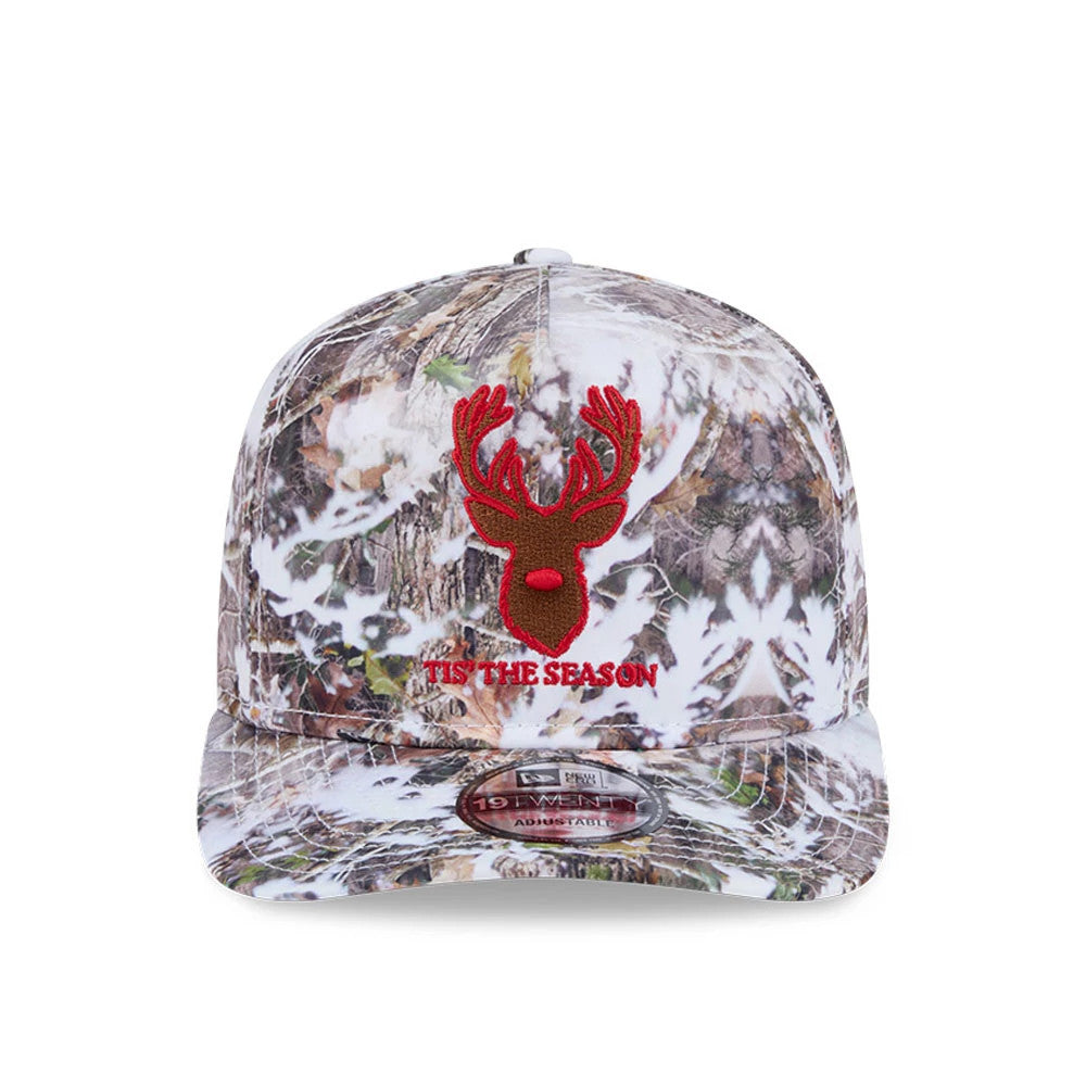 New Era Holiday Essentials Photoreal 19TWENTY Adjustable Cap, front view showing a red embroidered deer head and 'Tis The Season lettering on the photoreal tree pattern, with a 19TWENTY size sticker on the curved visor.