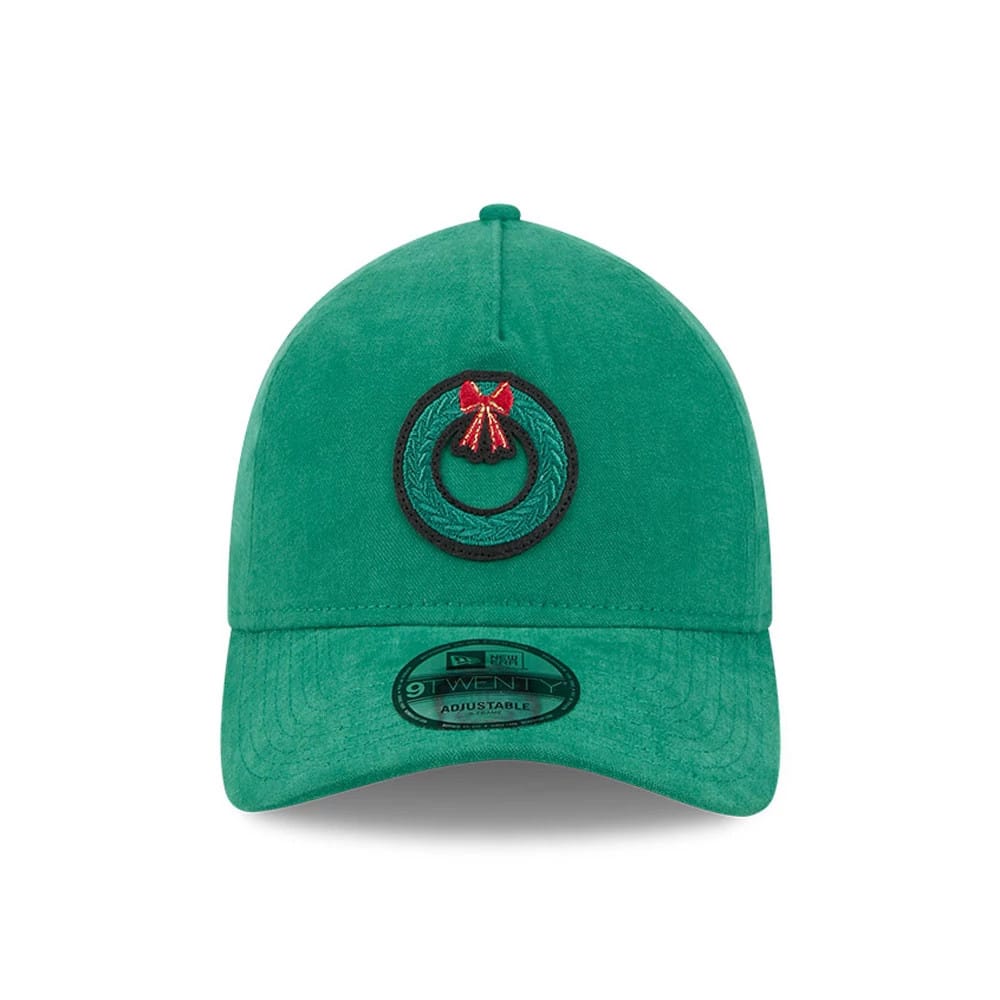 New Era Holiday Essentials Green 9TWENTY A-Frame Adjustable Cap, front view showing a green embroidered wreath with a red bow on the structured front panel, and a 9TWENTY size sticker on the curved green visor.
