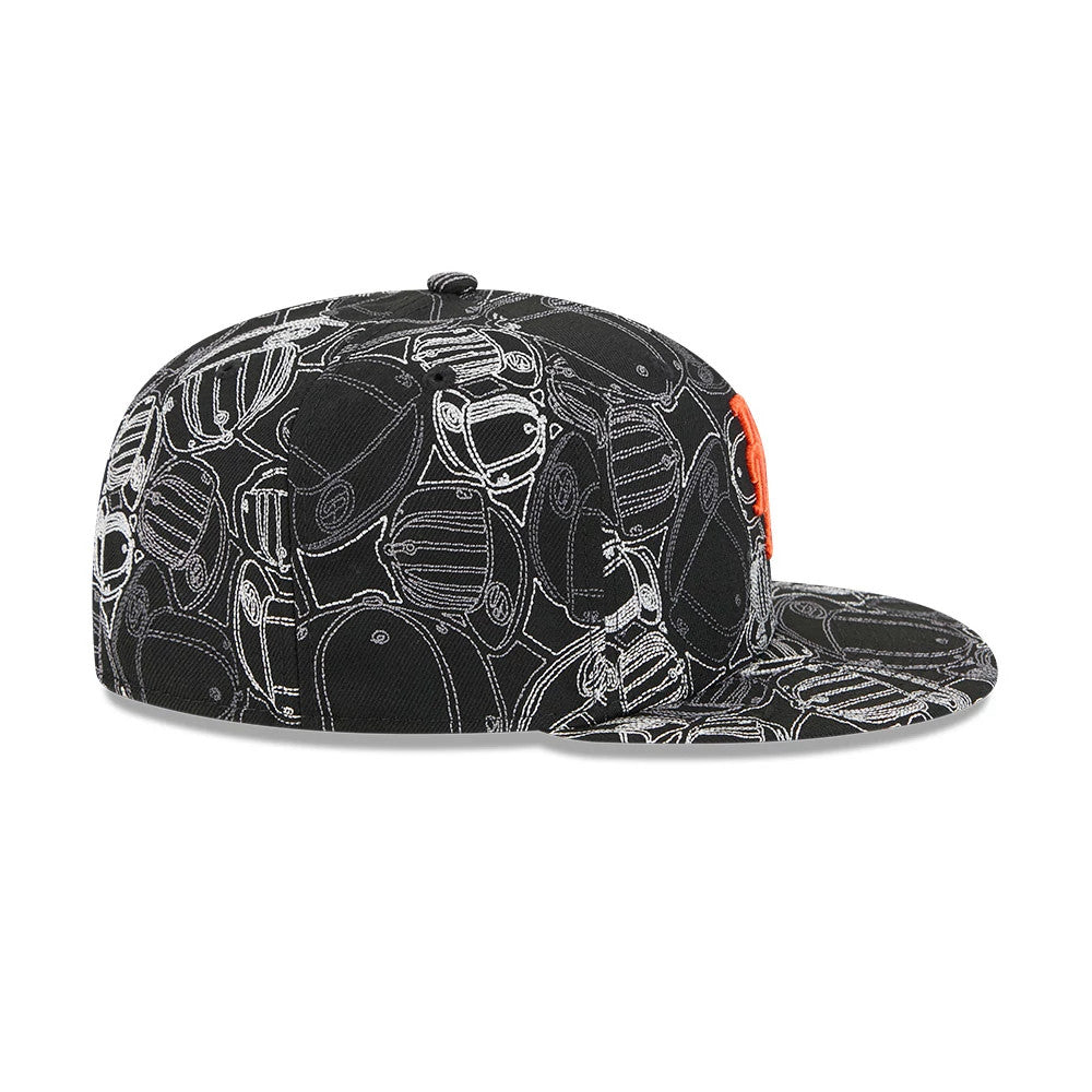 New York Mets MLB Cap Scramble Black New Era 59FIFTY Fitted Cap, side view showing an orange embroidered Mets logo on the front panel and an all-over scramble graphic pattern on the black structured crown and flat visor.