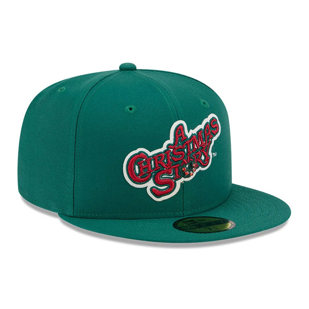 A Christmas Story Warner Brothers Green New Era 59FIFTY Fitted Cap, three-quarter view showing the red and white embroidered movie title logo on the front panel, with a flat green visor and gold 59FIFTY size sticker.