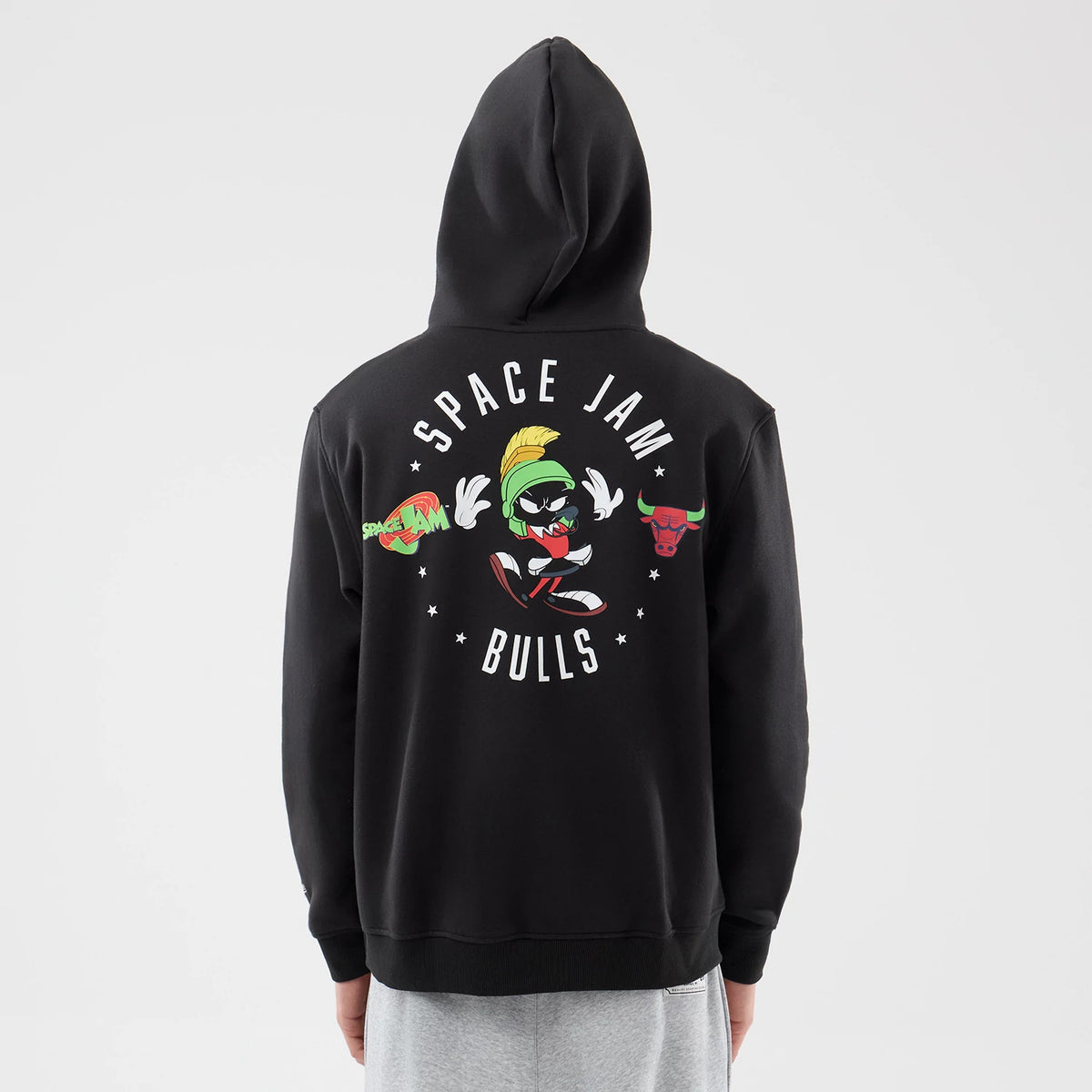 New Era Chicago Bulls Space Jam 2 X NBA Black Pullover Hoodie, back view on a model displaying a graphic of Marvin the Martian between Space Jam and Bulls lettering with small stars across the upper back.