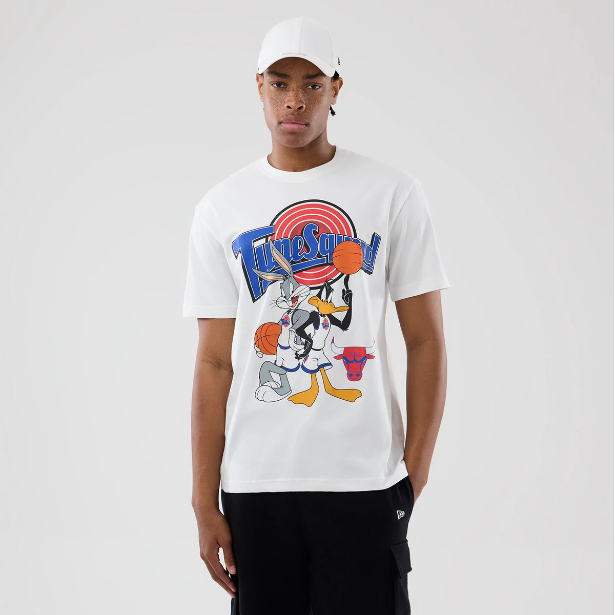 New Era Chicago Bulls Space Jam 2 X NBA White T-Shirt, front view on-model displaying a large graphic with Bugs Bunny, Daffy Duck and a basketball, with the Tune Squad logo above and the Chicago Bulls emblem below.