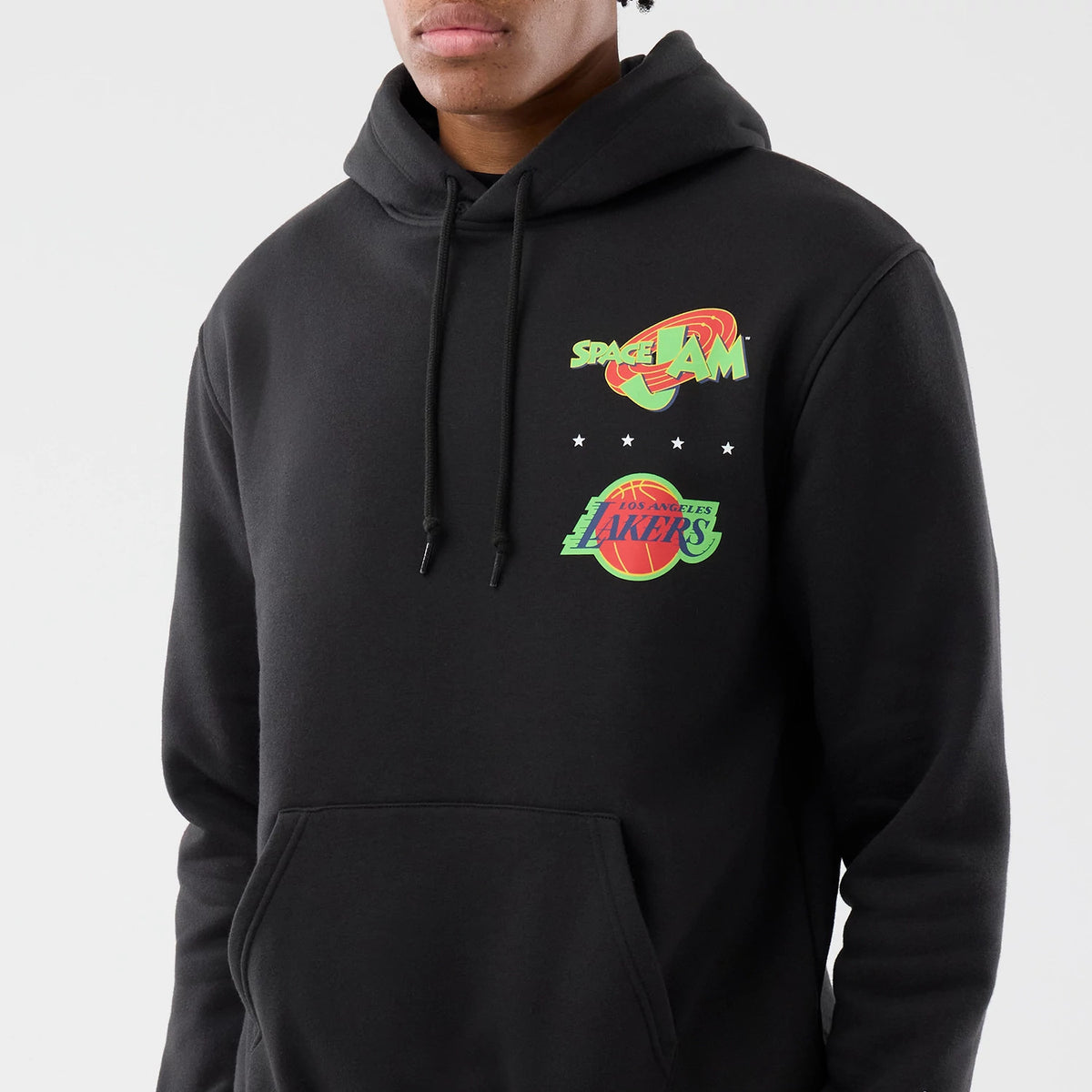 New Era LA Lakers Space Jam 2 X NBA Black Pullover Hoodie, front view on a model showing the green and red Space Jam logo above the Los Angeles Lakers logo on the chest with a pocket below and black drawstrings on the hood.
