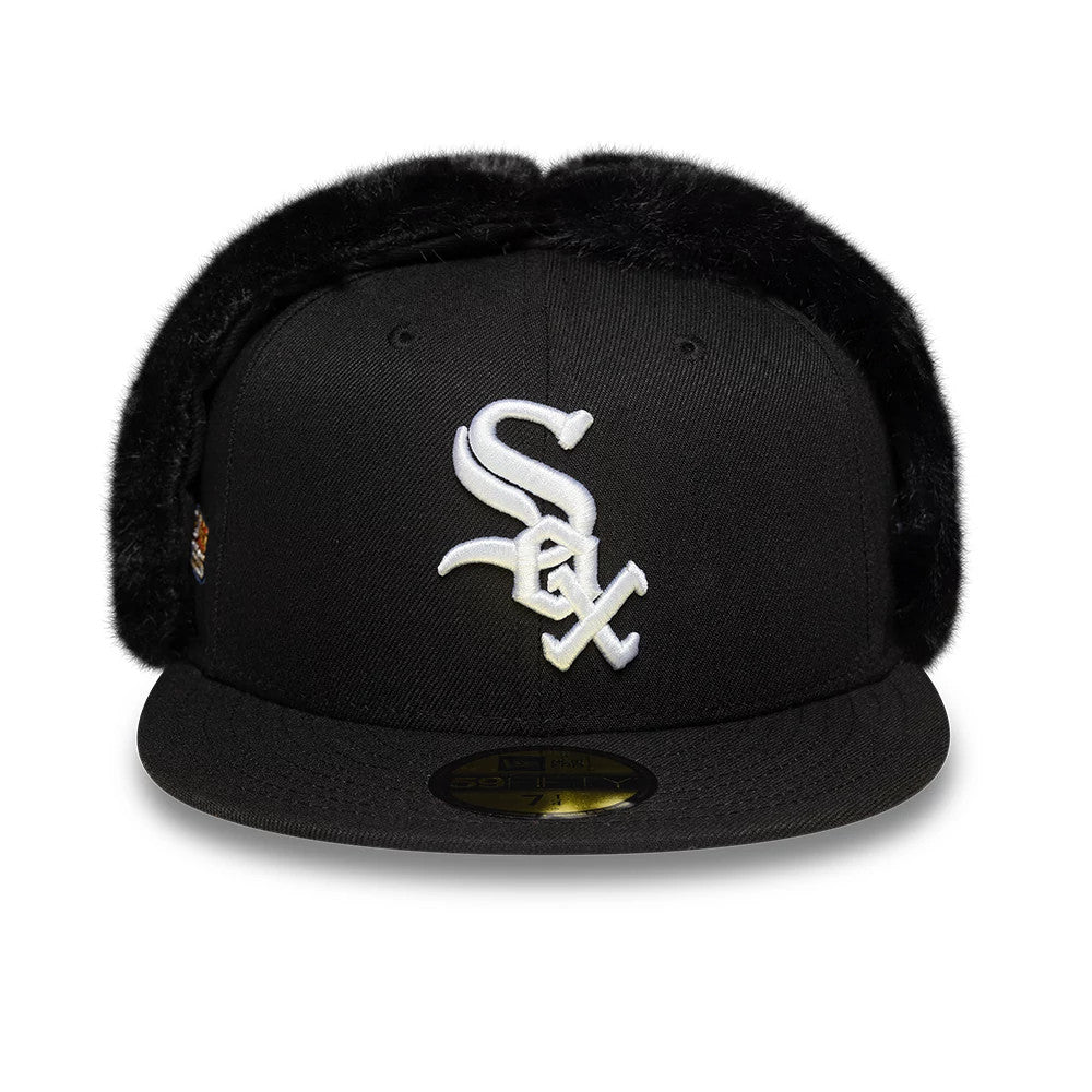 Chicago White Sox MLB World Series Black Dogear New Era 59FIFTY Fitted Cap, front view showing the raised white Sox logo embroidered on the black crown, with plush black dogear flaps and a gold 59FIFTY size sticker on the flat visor.