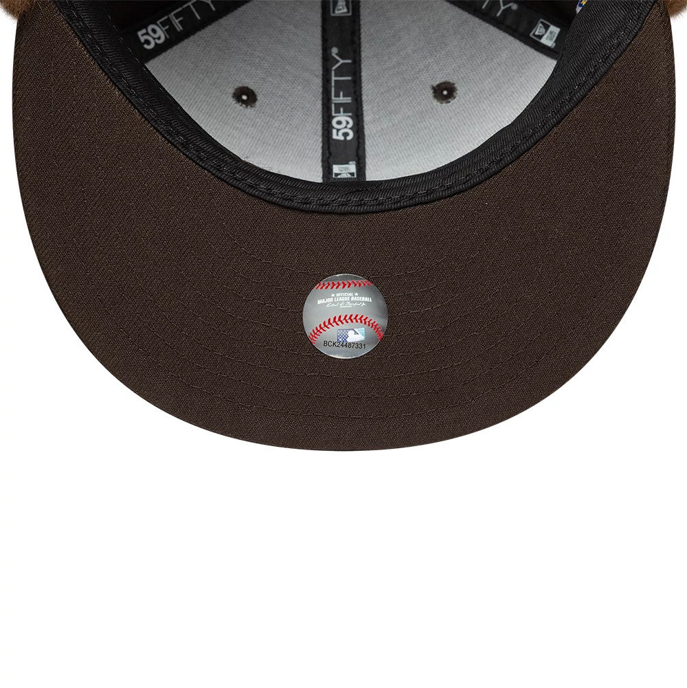 Pictured is this MLB World Series New York Yankees Dogear 59FIFTY Fitted cap in dark brown. 11