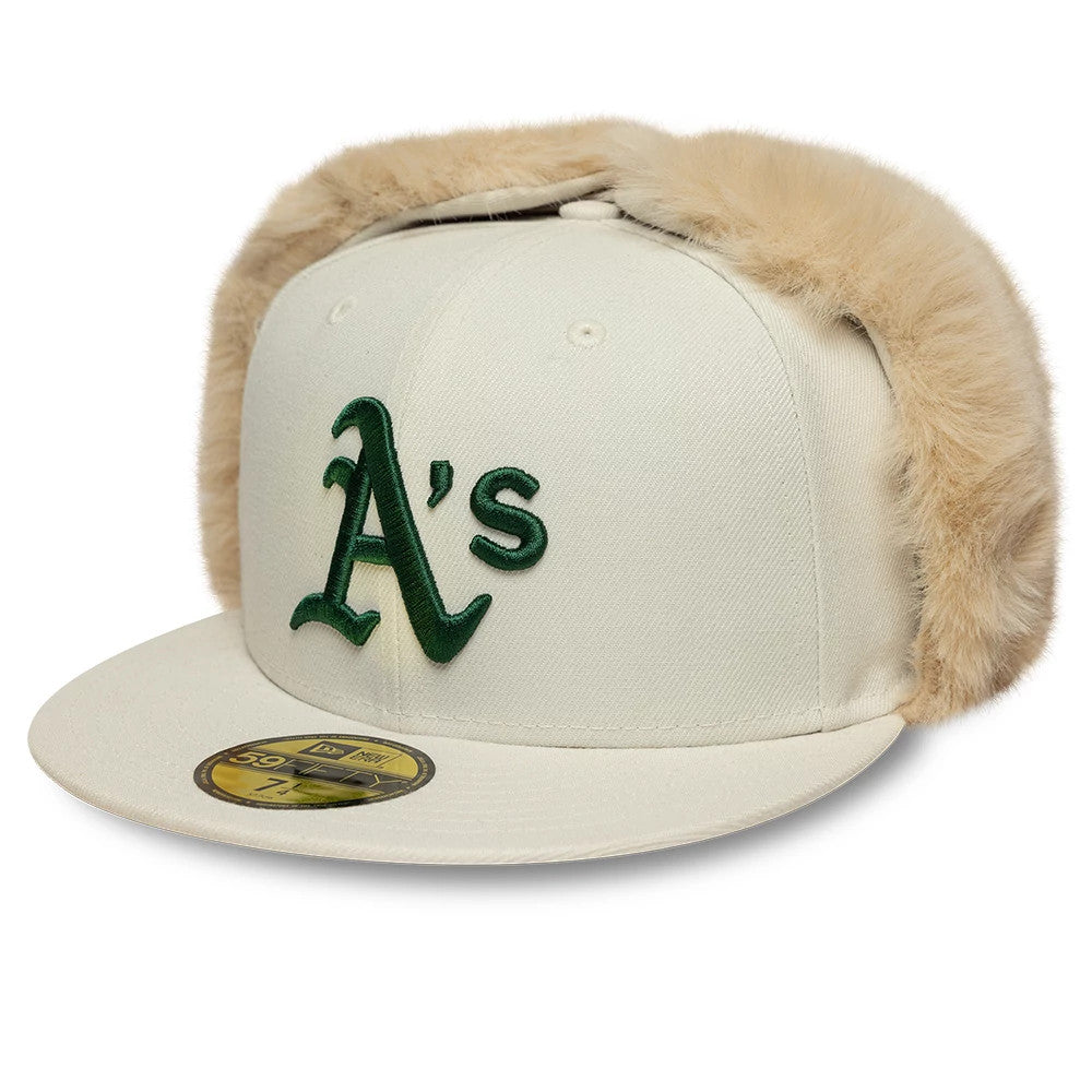 Athletics MLB World Series Cream Dogear New Era 59FIFTY Fitted Cap, front view showing green embroidered A's logo on the creamy crown with beige faux fur dogear flaps and a gold 59FIFTY size sticker on the visor.