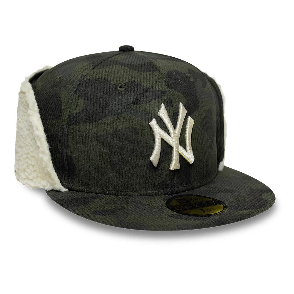 New York Yankees MLB Cord Green Downflap New Era 59FIFTY Fitted Cap, three-quarter view showing the raised white NY logo embroidered on the front panel, with black camo pattern, corduroy fabric, and cream downflaps.