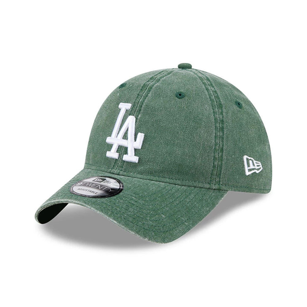 LA Dodgers MLB Overwash Dark Green New Era 9TWENTY Adjustable Cap, three-quarter view showing raised white LA logo on the front panel, curved visor, black and white 9TWENTY size sticker, and embroidered New Era flag logo on the left side.