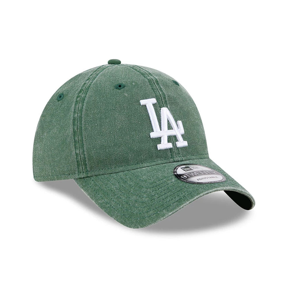 LA Dodgers MLB Overwash Dark Green New Era 9TWENTY Adjustable Cap, three-quarter view showing the white raised LA embroidered logo on the front panel, curved visor with 9TWENTY size sticker, and matching dark green top button.