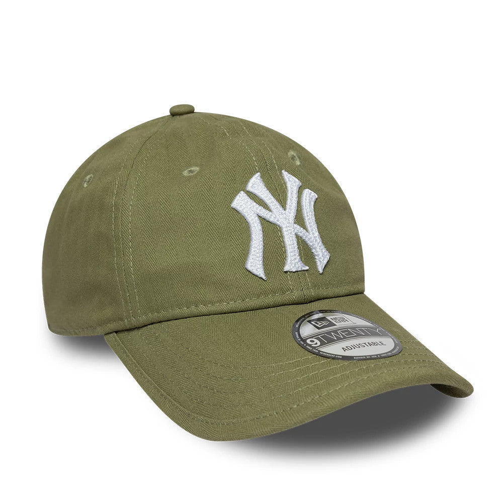 New York Yankees MLB Herringbone Green New Era 9TWENTY Adjustable Cap, three-quarter view showing the white embroidered NY logo on the structured green crown, with a 9TWENTY size sticker on the curved visor.