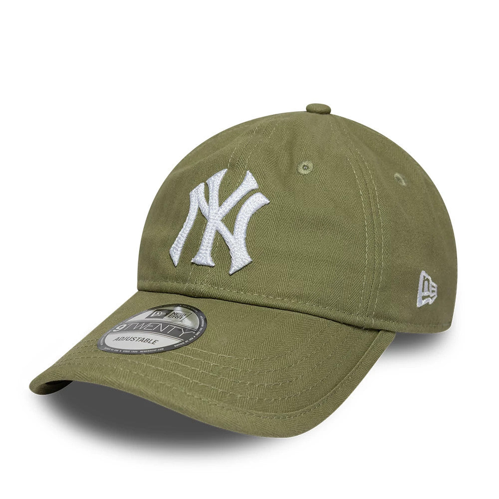 New York Yankees MLB Herringbone Green New Era 9TWENTY Adjustable Cap, three-quarter view showing the raised white NY logo on the front panel, curved green visor with the grey 9TWENTY size sticker, and embroidered New Era flag logo on the left side.