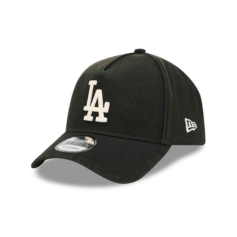 LA Dodgers MLB Washed Canvas Black New Era 9FORTY A-Frame Adjustable Cap, three-quarter view showing the white embroidered LA logo on the front panel, black curved visor with a 9FORTY size sticker, and New Era flag logo on the left side.