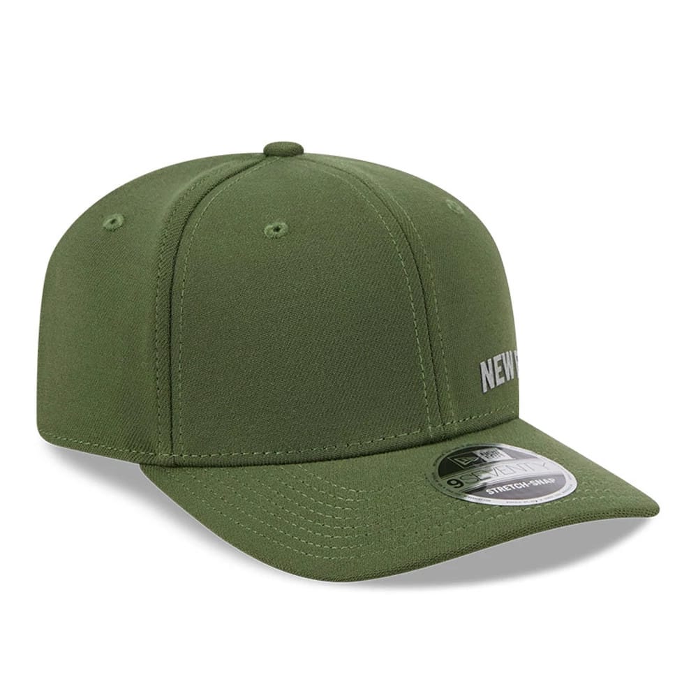 New Era Flawless Dark Green 9SEVENTY Stretch Snap Adjustable Cap, three-quarter view showing silver embroidered New Era logo on the left side of the front panels, with a curved visor and 9SEVENTY size sticker on the visor.