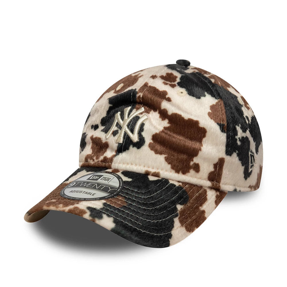 New York Yankees Animal Print Beige New Era 9TWENTY Adjustable Cap, three-quarter view showing white raised embroidered NY logo on the structured crown with a cow pattern and curved visor, complete with a 9TWENTY size sticker.
