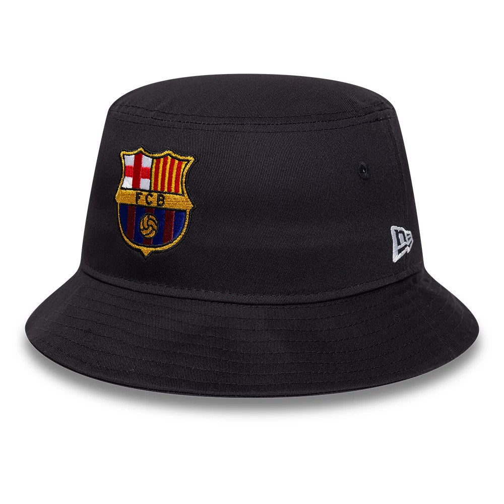 FC Barcelona Core Navy New Era Bucket Hat, three-quarter view showing the embroidered FC Barcelona crest on the front panel and the white New Era flag logo on the left side, with a classic visor and stitched detailing.