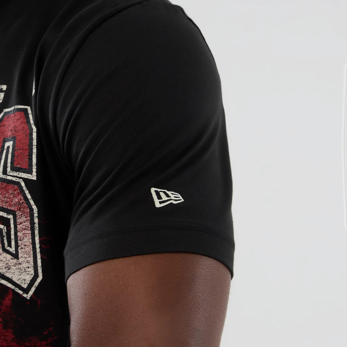 New Era Chicago Bulls NBA Hardwood Classic Black T-Shirt, side view showing a large distressed red and white number graphic spanning the chest and an embroidered New Era logo in white on the sleeve.