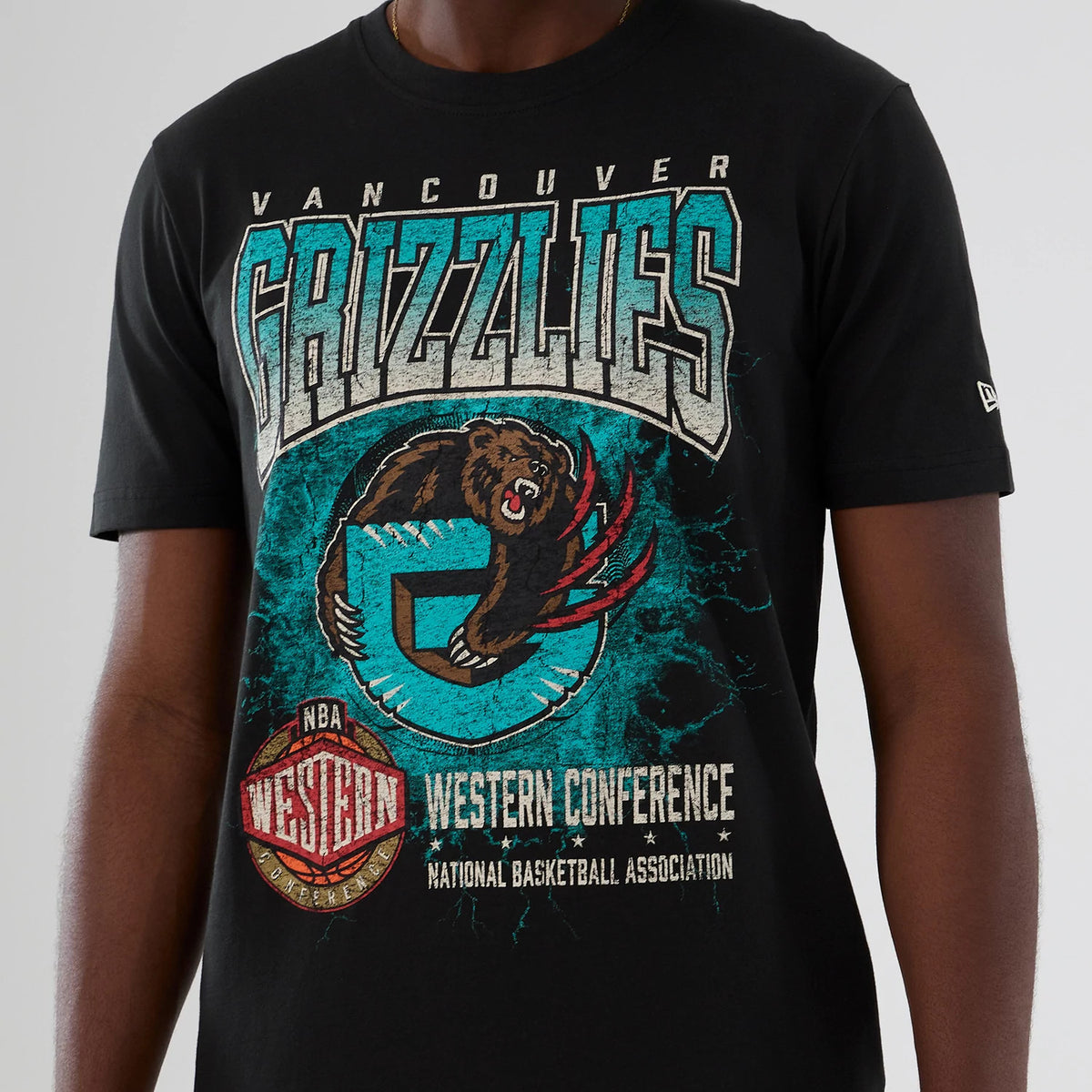 New Era Vancouver Grizzlies NBA Hardwood Classic Black T-Shirt, front view showing a distressed Grizzlies bear logo with teal accents, Vancouver Grizzlies lettering across the chest, and a small embroidered New Era logo on the left sleeve.