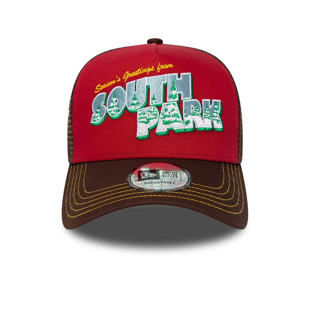 South Park Dark Red New Era 9FORTY A-Frame Trucker Adjustable Cap, front view showing Season’s Greetings from South Park in raised white and green embroidery on the red front panel, with a brown visor and 9FORTY size sticker.