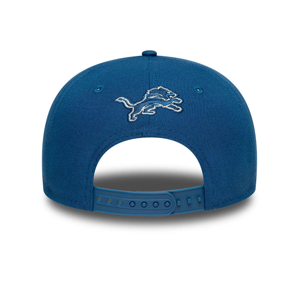 Detroit Lions Fear Of God x NFL Blue Retro Crown New Era 9FIFTY Adjustable Cap, rear view showing the white embroidered Detroit Lions logo on the centre of the structured blue crown above the matching blue snapback closure.