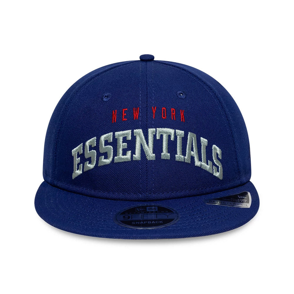 New York Giants Fear Of God x NFL Dark Blue Retro Crown New Era 9FIFTY Adjustable Cap, front view showing raised white Essentials embroidery on the front panel, with red New York lettering above and a black 9FIFTY size sticker on the flat visor.