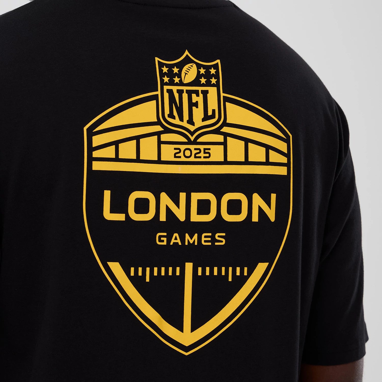 The Male model is wearing Minnesota Vikings NFL International Series Games 2025 Black Oversized T-Shirt 4