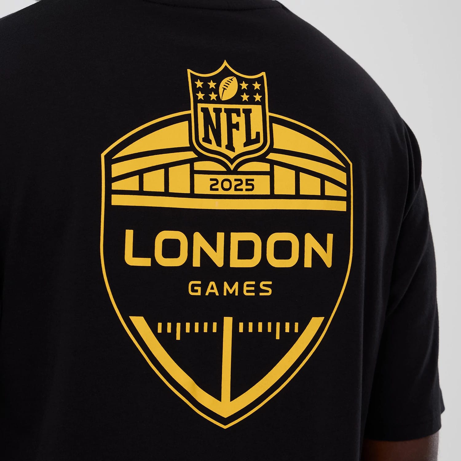 The Male model is wearing Minnesota Vikings NFL International Series Games 2025 Black Oversized T-Shirt 4