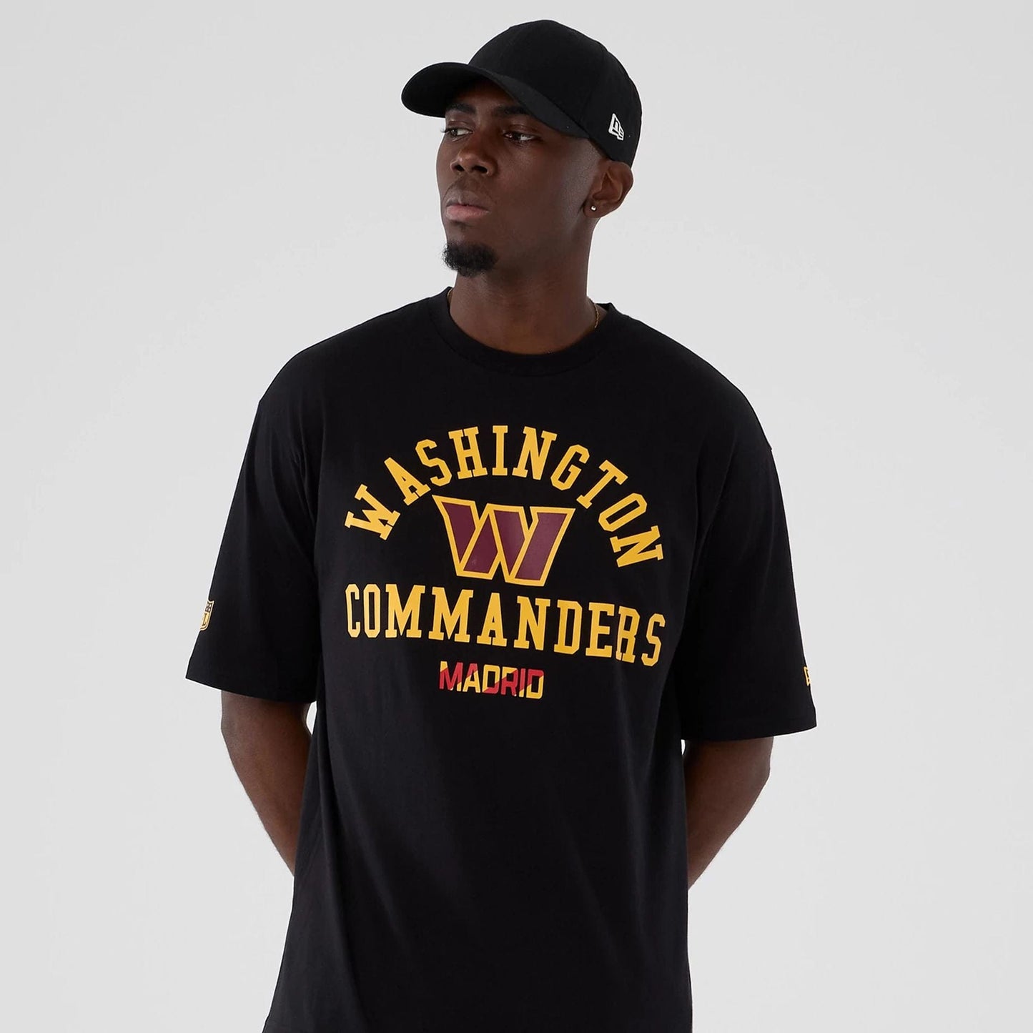 The Male model is wearing Washington Commanders NFL International Series Games 2025 Black Oversized T-Shirt 7