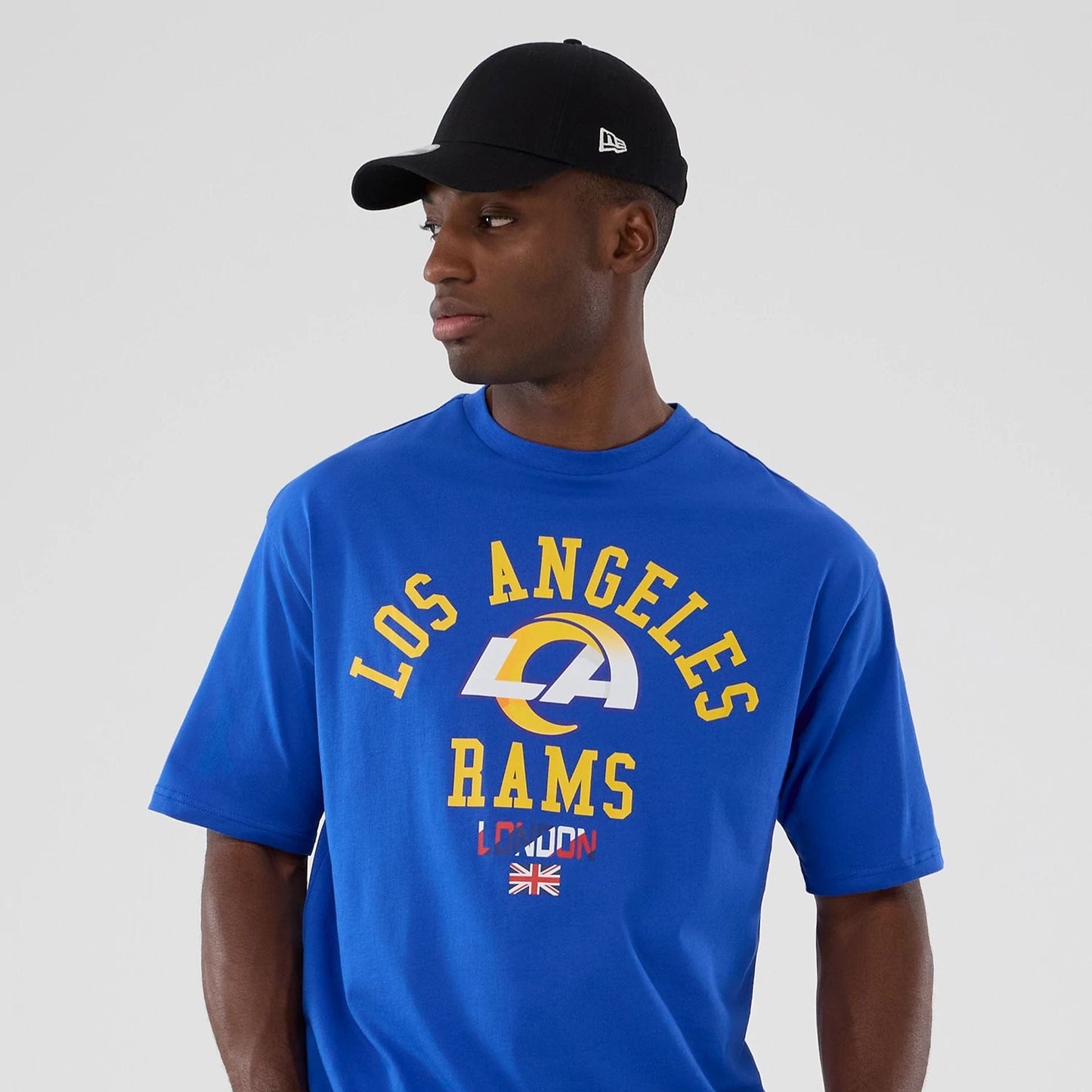 The Male model is wearing LA Rams NFL International Series Games 2025 Bright Blue Oversized T-Shirt 7