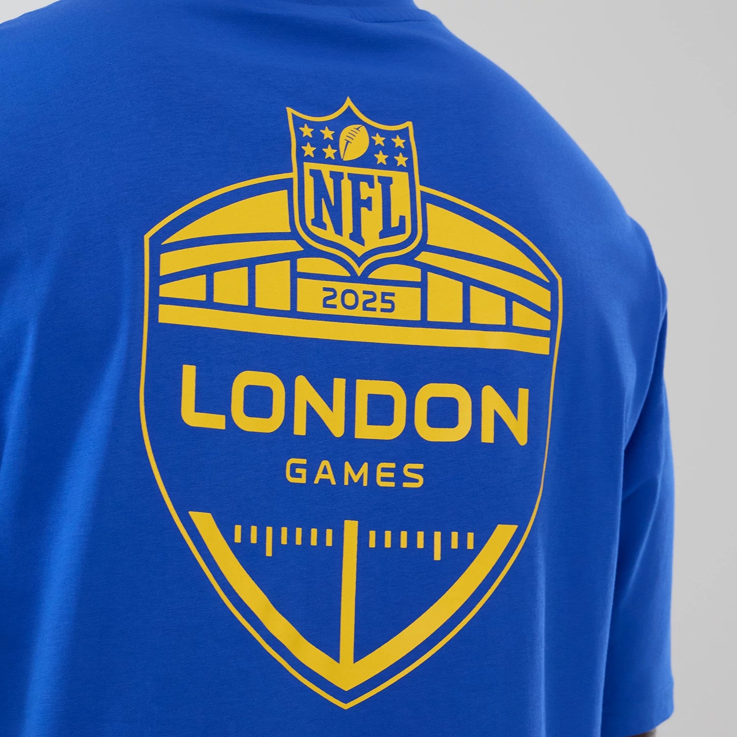 The Male model is wearing LA Rams NFL International Series Games 2025 Bright Blue Oversized T-Shirt 4