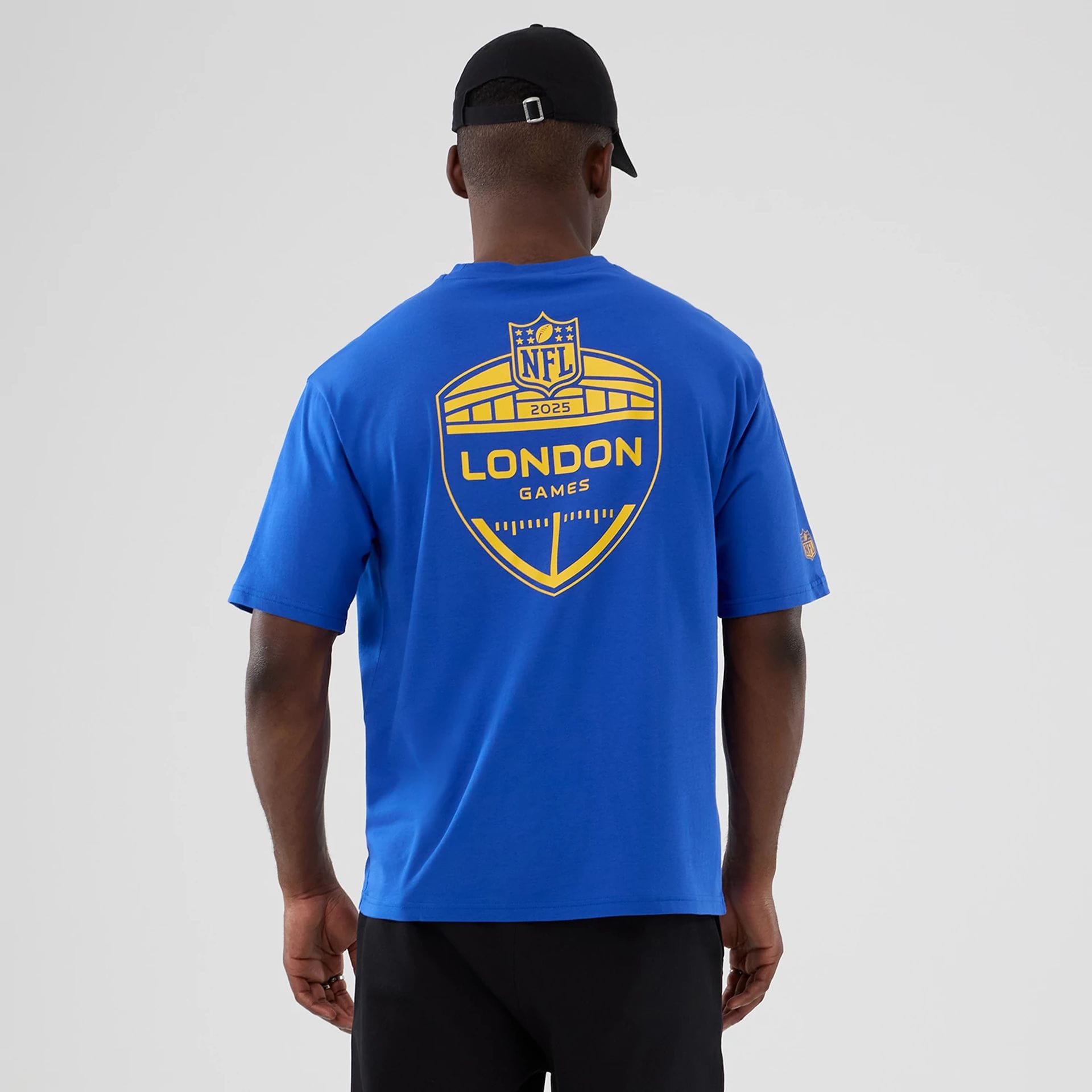 The Male model is wearing LA Rams NFL International Series Games 2025 Bright Blue Oversized T-Shirt 2
