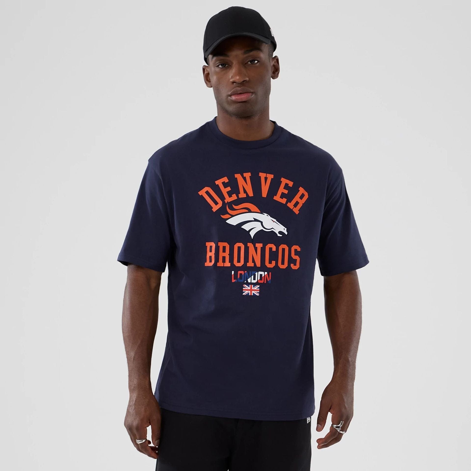 The Male model is wearing Denver Broncos NFL International Series Games 2025 Navy Oversized T-Shirt 1