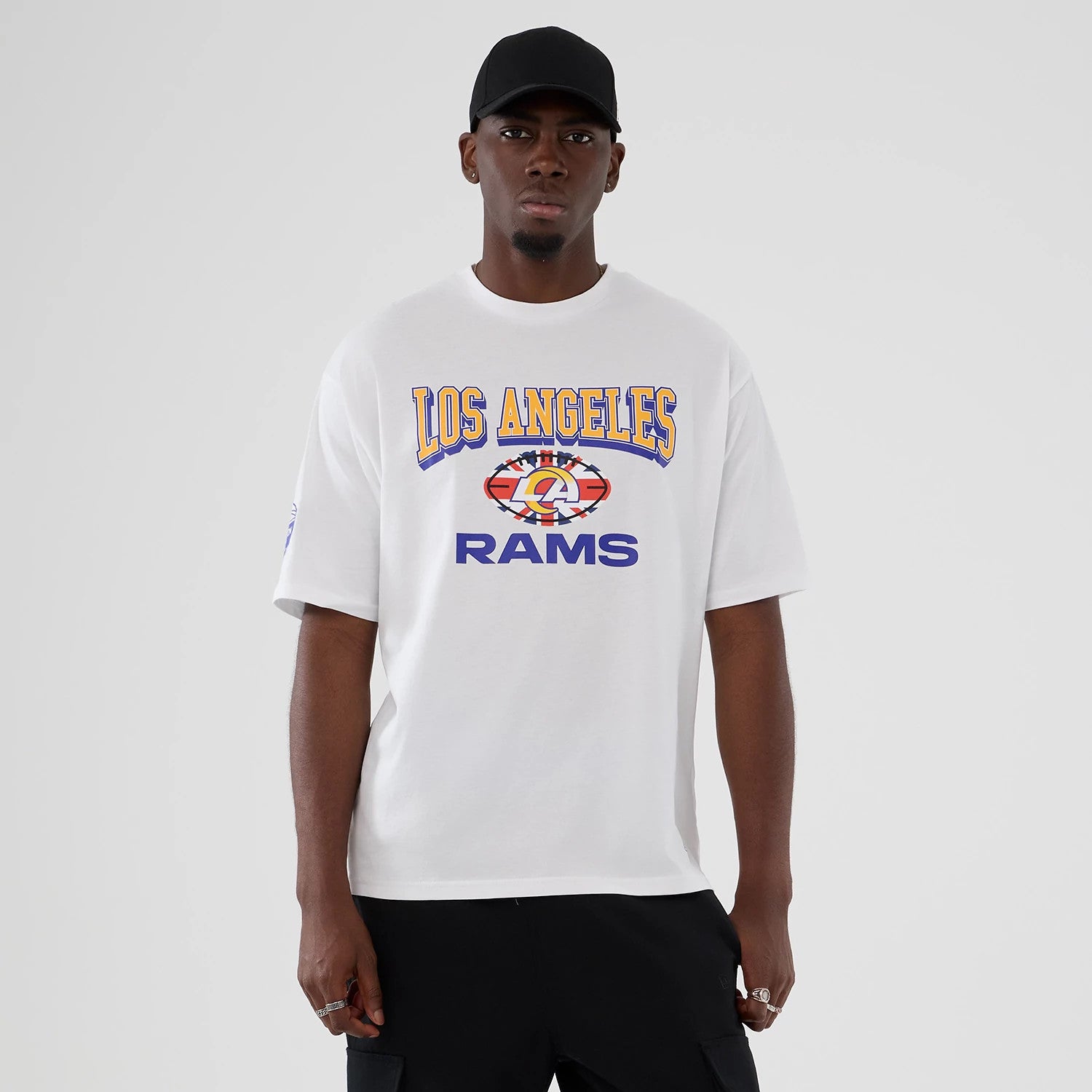 The Male model is wearing LA Rams NFL International Series Games 2025 White Oversized T-Shirt 1