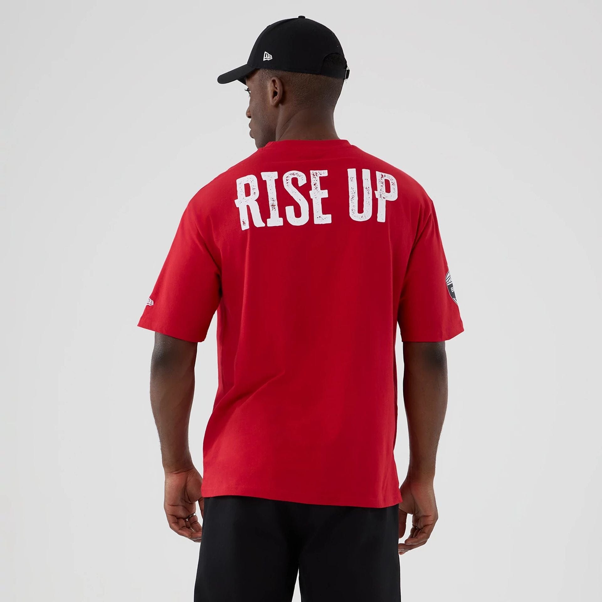 The Male model is wearing Atlanta Falcons NFL International Series Games 2025 Red Oversized T-Shirt 2